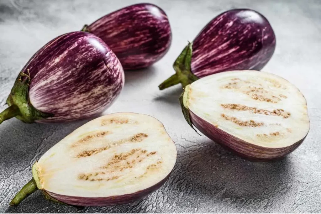 What is Baba Ganoush served in a bowl with olive oil and herbs, surrounded by pita bread slices