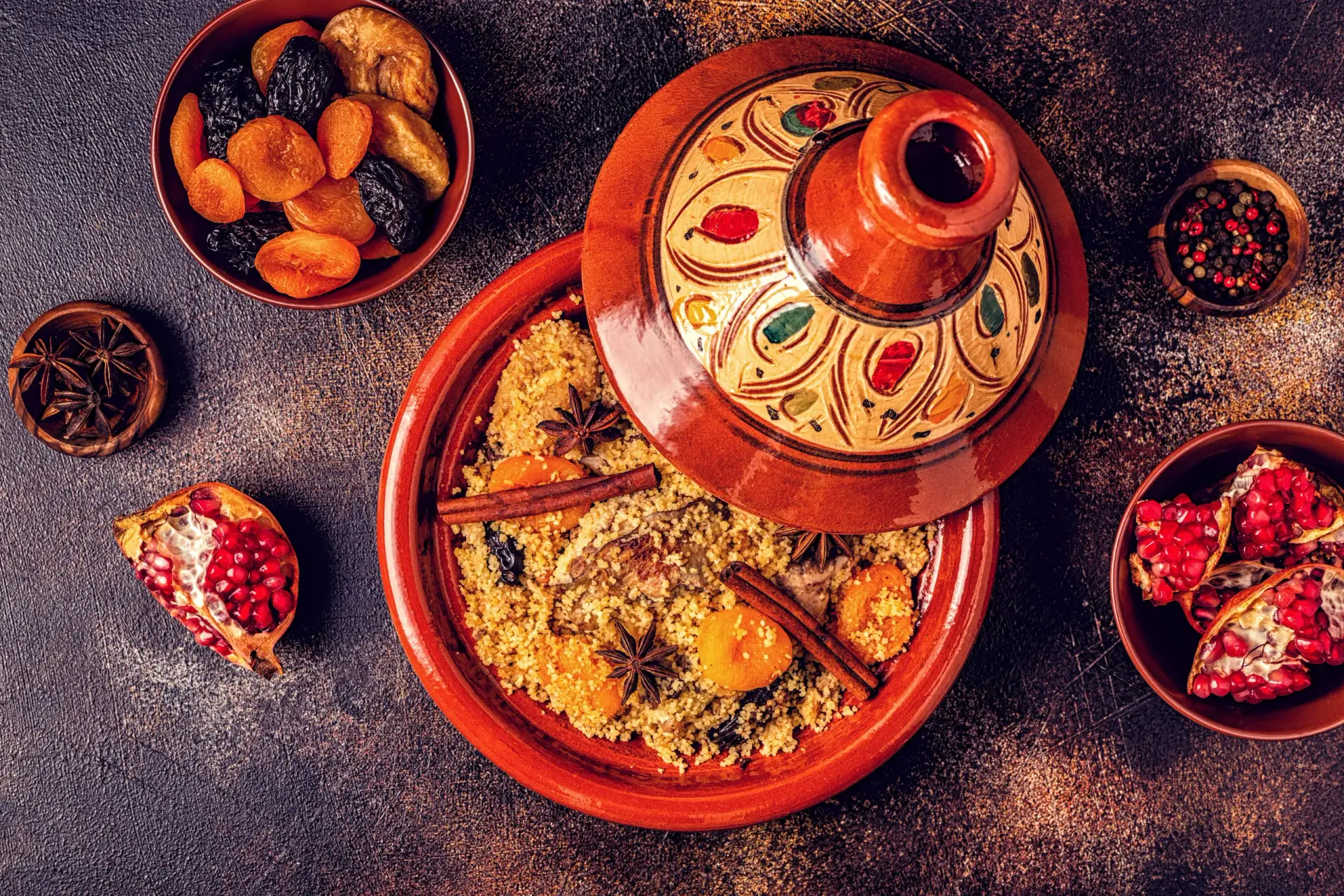 Traditional Moroccan tagine with couscous, dried fruits, and spices – Mediterranean catering dish at Aladdin Houston