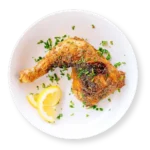 Baked chicken leg quarter from Aladdin Mediterranean Cuisine—crispy golden skin, juicy meat.