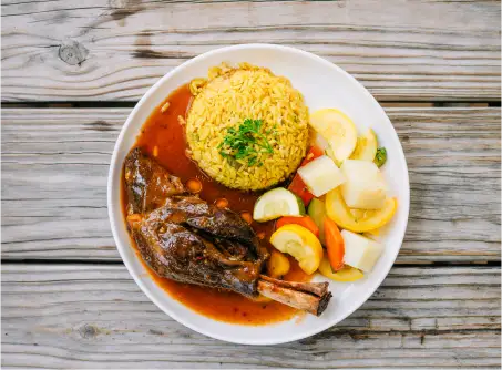 braised Lamb shank with saffron rice and steamed veggies only at aladdins houston