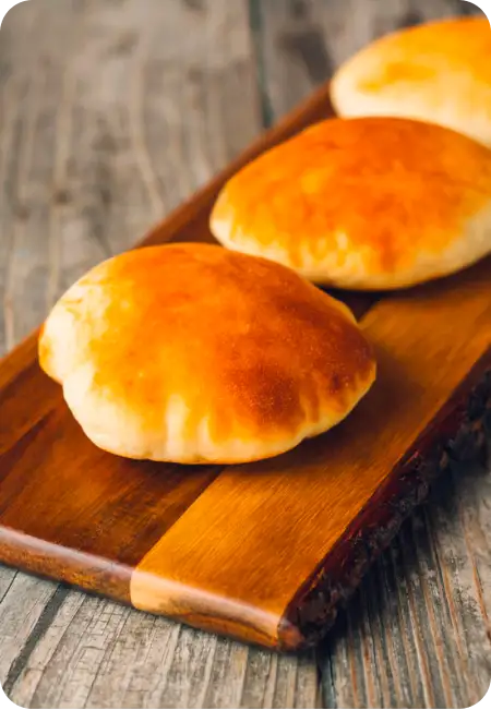 a group of bread on a wood board