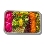 Colorful Mediterranean relish tray with pickles, olives, carrots, mint, and lemon slices from Aladdin Mediterranean Cuisine in Houston.