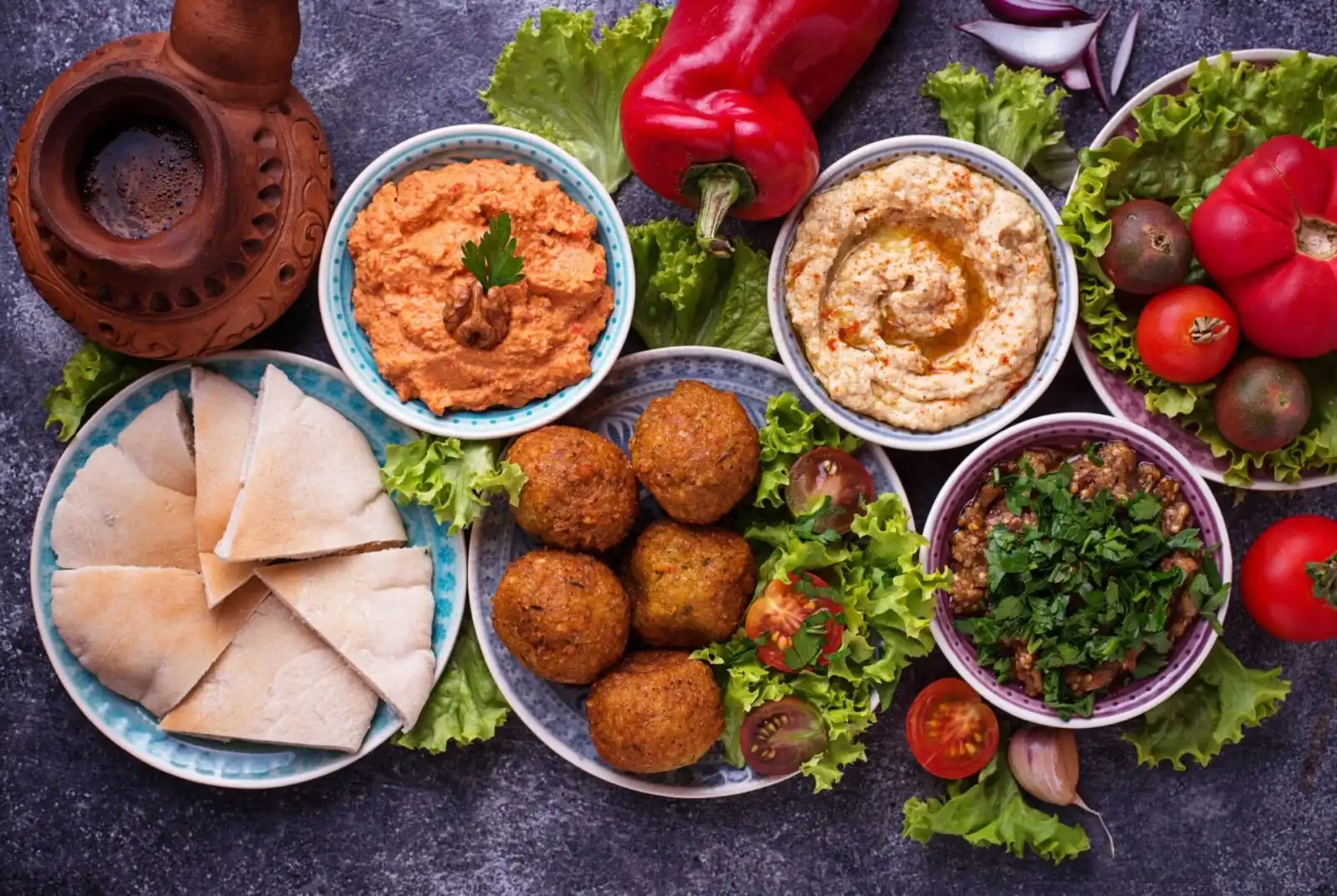 Selection of Middle eastern or Arabic dishes. Traditional Falafel, hummus, pita and muhammara. Top view