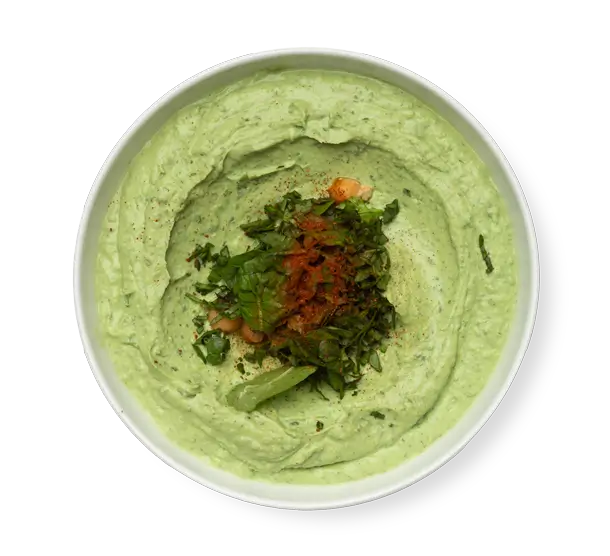 Spinach Hummus a green dip on a white plate
