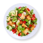 Lebanese Fattoush Salad with pita chips croutons on a round white plate