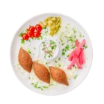 Kibbie plate served with pickles, onions, tomatoes, and tzatziki sauce at Aladdin Mediterranean Grill Houston