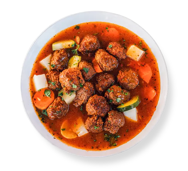 Gluten-free spicy lamb meatballs in smoky chipotle gravy, plated at Aladdins Houston