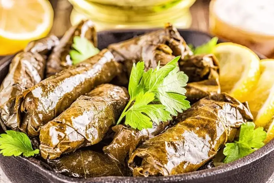 Grape leaves stuffed with herbed rice and olive oil, served with lemon wedges. A refreshing Mediterranean classic at Aladdin Houston.