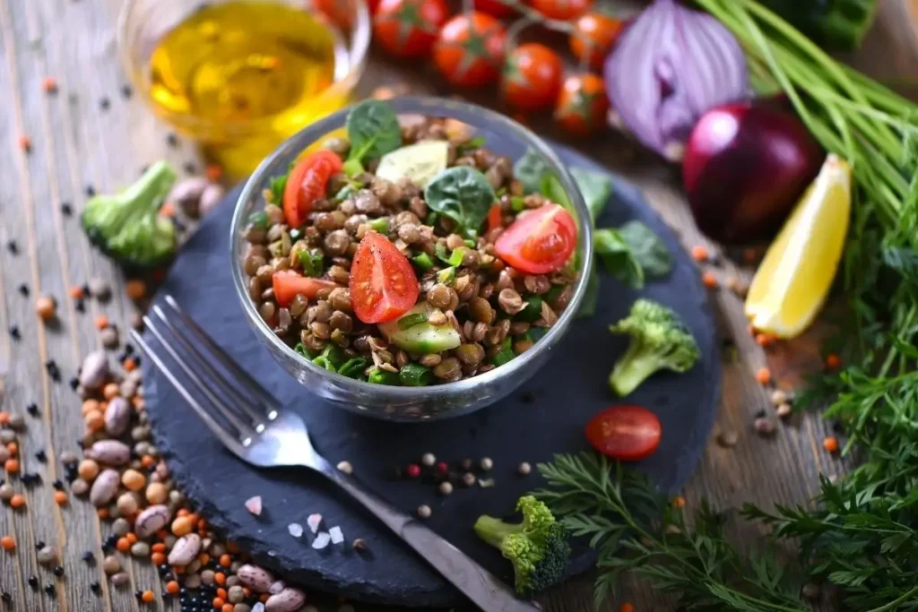 Bowl of lentil salad with tomatoes, cucumber, spinach, and herbs at Aladdin Mediterranean cuisine, a spot for healthy Mediterranean food in Houston.
