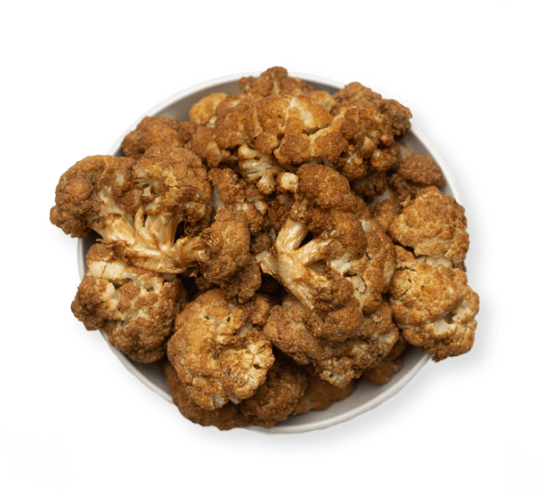 Golden roasted cauliflower florets seasoned with Mediterranean spices at Aladdin Mediterranean Cuisine Houston.