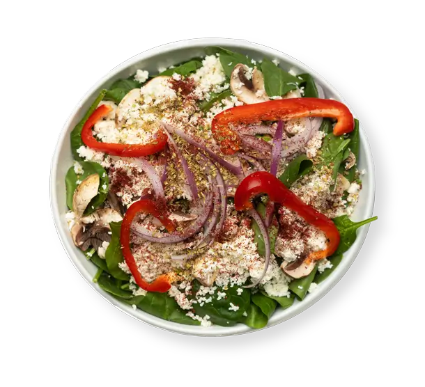 Fresh Spinach Feta Salad with red peppers, onions, and mushrooms from Aladdin Mediterranean Grill in Houston.