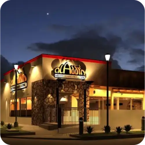 Exterior view of Aladdin Mediterranean Cuisine Montrose at night, a popular Mediterranean restaurant in Houston, Texas.